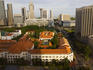 Overhead of historic Raffles Hotel and Singapore skyline.