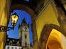 Astronomical Tower at dusk framed by arcade arch and lamp.