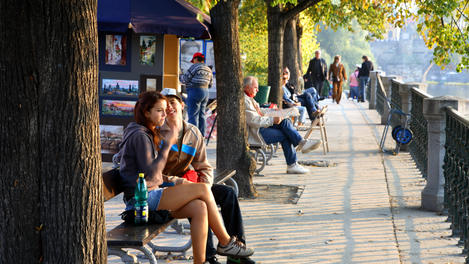 Autumn colours and people along Vltava Moldau River.