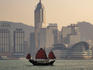 Sightseeing junk on Victoria Harbour with Hong Kong Convention and Exhibition Centre and Wan Chai skyline in background.