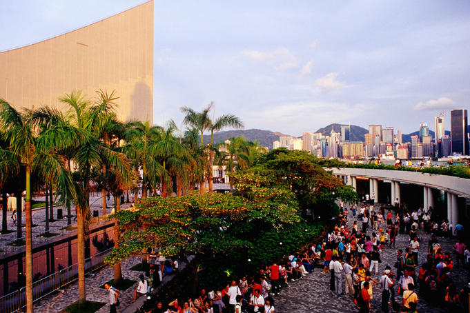 Tourists on Tsim Sha Tsui Promenade near Cultural Centre.