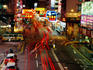 Traffic and neon signs in Causeway Bay at dusk.