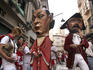Papier-mache giant heads on street near Calle Estafeta bonking people with their padded sticks.