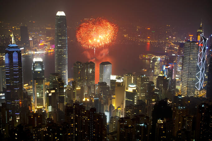 Fireworks over harbour at night.