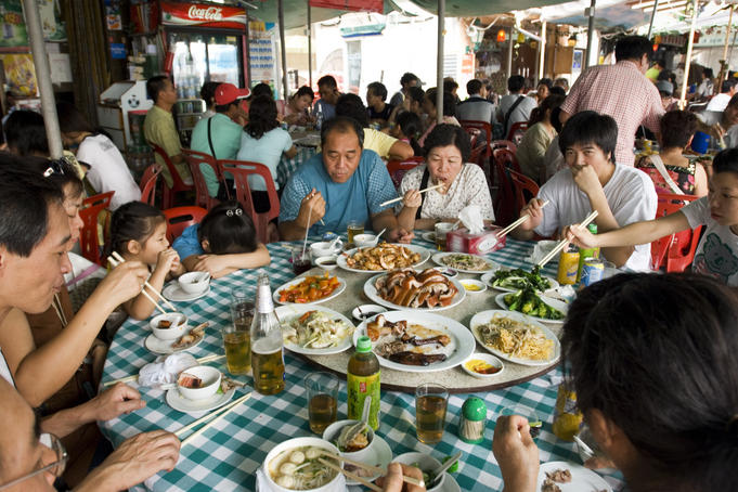 Family sharing meal at waterfront restaurant, Cheung Chau village.