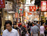 Crowds of tourists in street.