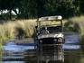 Four wheel drive vehicle crossing deepening waters of the Delta.