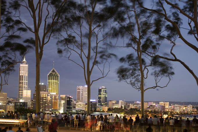 People in Kings Park watching fireworks on Australia Day with Perth skyline in background.