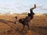 Boys playing on edge of soccer field.