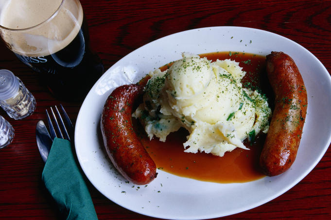 Bangers ( sausages ), mash ( poatato ) and a beer