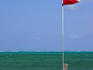 Man lying on jetty with flag.