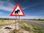 'Watch for elephants sign' on the side of a road.