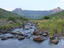 Sunrise over stream with Table Mountain in background.