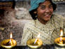 Young girl lighting candles at Swayambhunath temple.