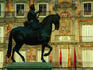 Statue of Felipe III in Plaza Mayor with Casa de Panaderia in background.
