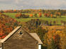 Farm house surrounded by trees in autumn colour.