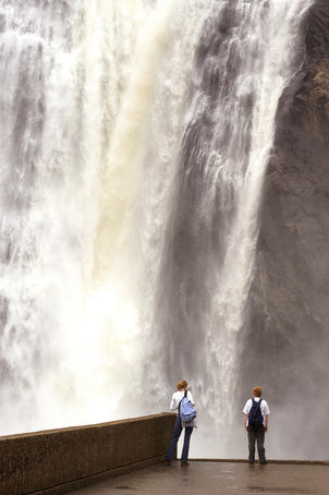 People standing below Montmorency Falls.