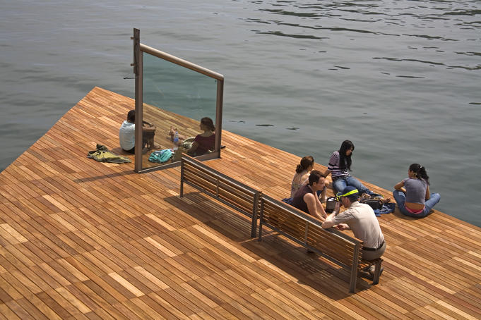 People relax on Rambla de Mar, Port Vell, Barcelona