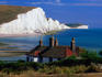 Cottages with Seven Sisters cliffs in background, South Downs, East Sussex.