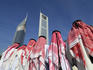 Traditional dancers with Emirates Towers in background.