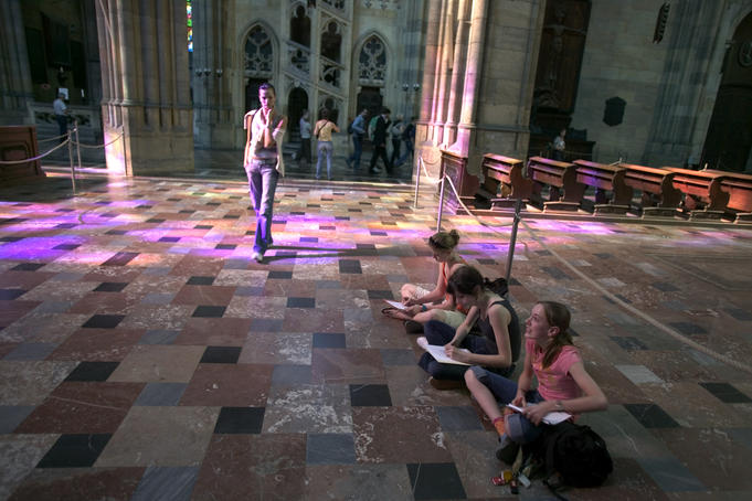 Local students sketching with tourists in background, St. Vitus Cathedral, Prague Castle, Hradcany.