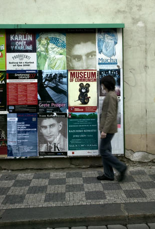 Local man passing billboard with Kafka posters.
