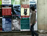 Local man passing billboard with Kafka posters.