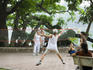 Morning badminton game beside Hoan Kiem Lake.