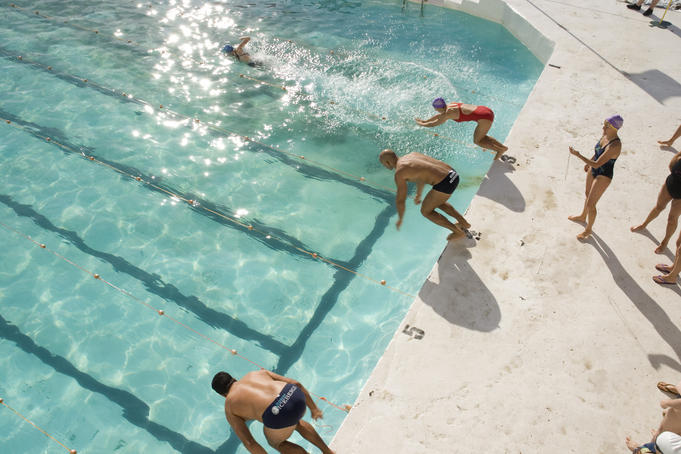 Overhead of swimmers diving into Bondi Icebergs pool.