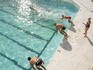 Overhead of swimmers diving into Bondi Icebergs pool.
