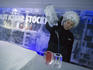 Woman serving vodka drinks in ice glasses at Absolut Icebar, Nordic Sea Hotel.