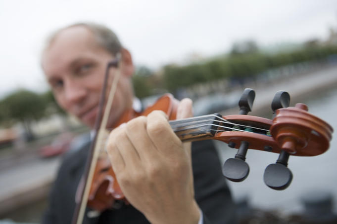 Violinist playing welcome aboard music at MS Europa.