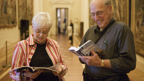 Visitors with Lonely Planet Guidebook inside Winter Palace.