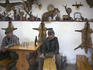 Men having a beer in local hunting bar decorated with stuffed animals, Transylvania.