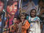 Young girls in front of movie posters.
