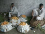 Fruit sellers smoke a pipe in the market.