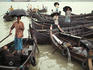 Ferryman taking shelter in the monsoon rains.