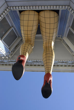 Model of woman's legs on side of building, Haight Street.