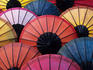 Lacquered umbrellas for sale at evening street market.