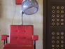 Red chair and coin-operated hair dryer at Gellert Baths.