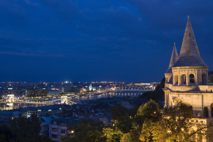 Fisherman's Bastion at night with city lights below.