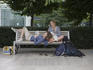 Two girls and dog relaxing on park bench in Pest.