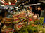 Customers inspecting fresh produce at Pike Place Market.