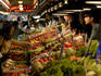 Customers inspecting fresh produce at Pike Place Market.