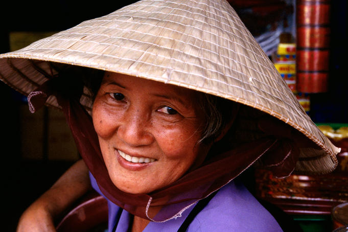 Vietnamese woman wearing traditional hat.