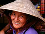 Vietnamese woman wearing traditional hat.