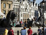 Bronze Lions at Trafalagar Square with Whitehall architecture in background.