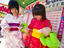 Two young girls dressed in kimonos read their fortune as told by cards at the Sapporo Matsuri Festival.