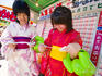 Two young girls dressed in kimonos read their fortune as told by cards at the Sapporo Matsuri Festival.