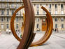 Modern iron sculptures contrast with the eighteenth century buildings in the background.